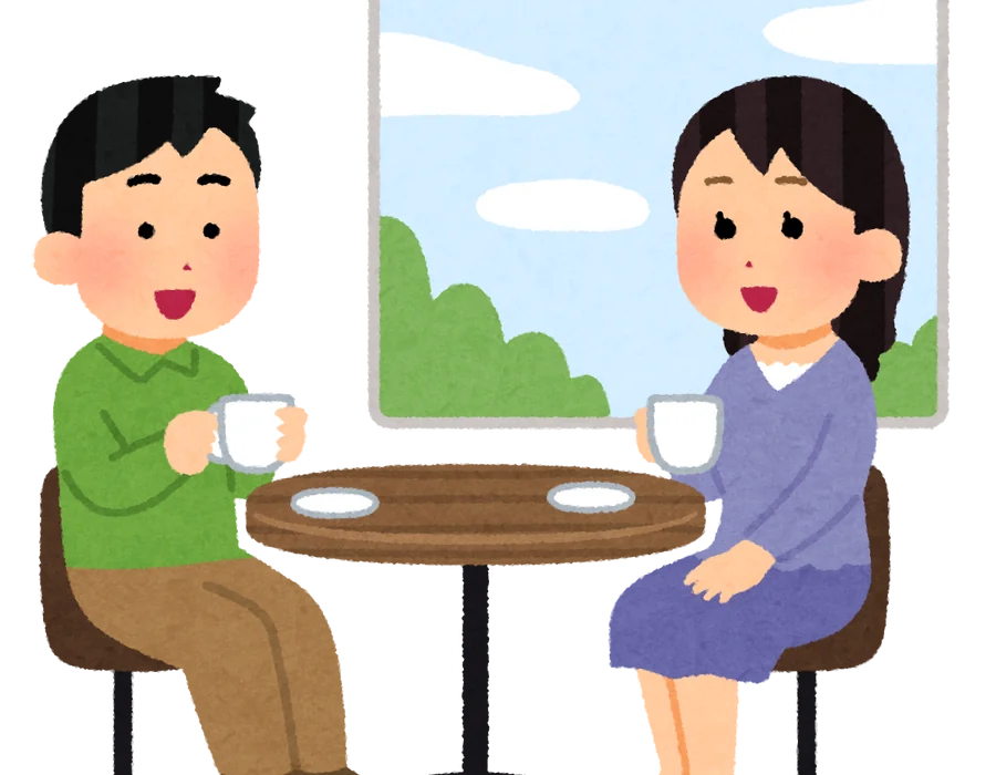 Two people talking over coffee at a café table